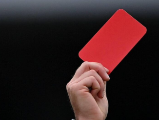 GAA match official brandishing a red card
